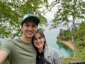 Assistant Coach Mitchell taking selfie with wife along Lake Superior shoreline